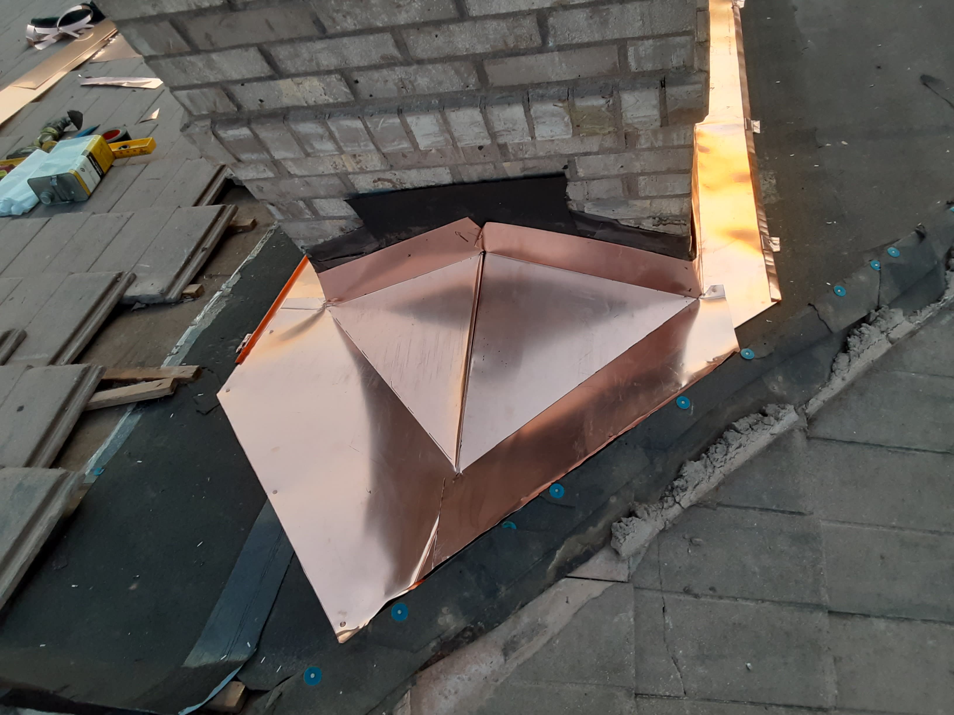 Copper chimney saddle and cricket installation