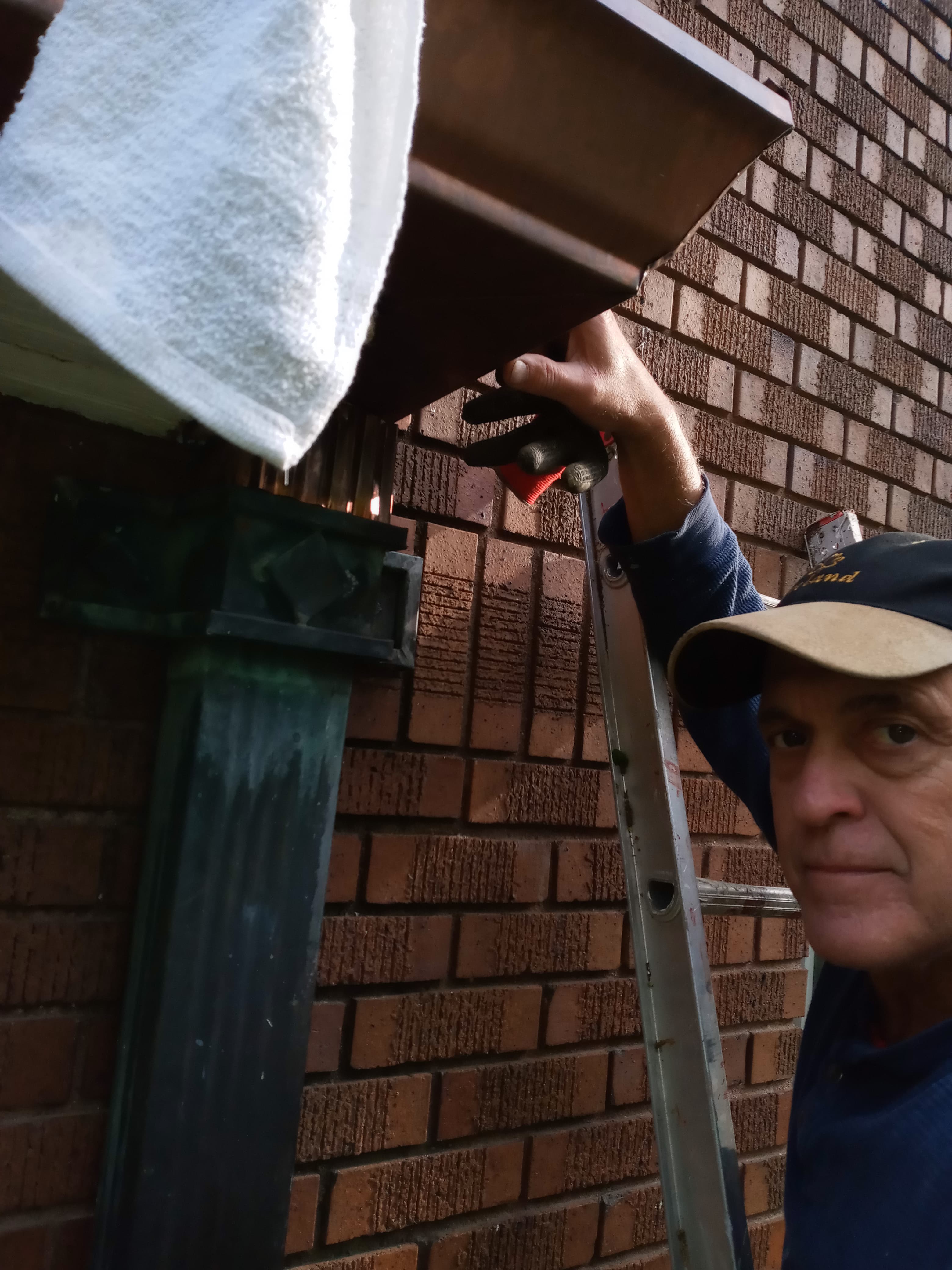 Alexander installing copper downspout